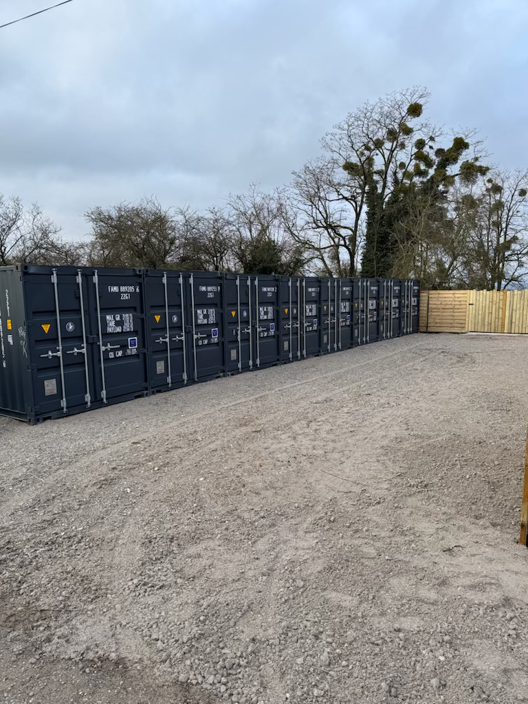 Alignement containers self-stockage 20 pieds gris anthracite clôture bois