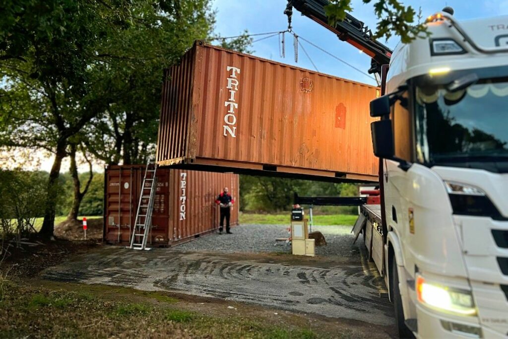 Livraison de containers 20 pieds par camion grue à Pompaire, un container déjà posé, l'autre en cours d'installation
